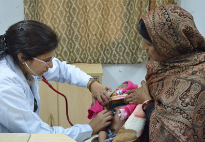 doctor checking a baby , sitting on his mother couch 